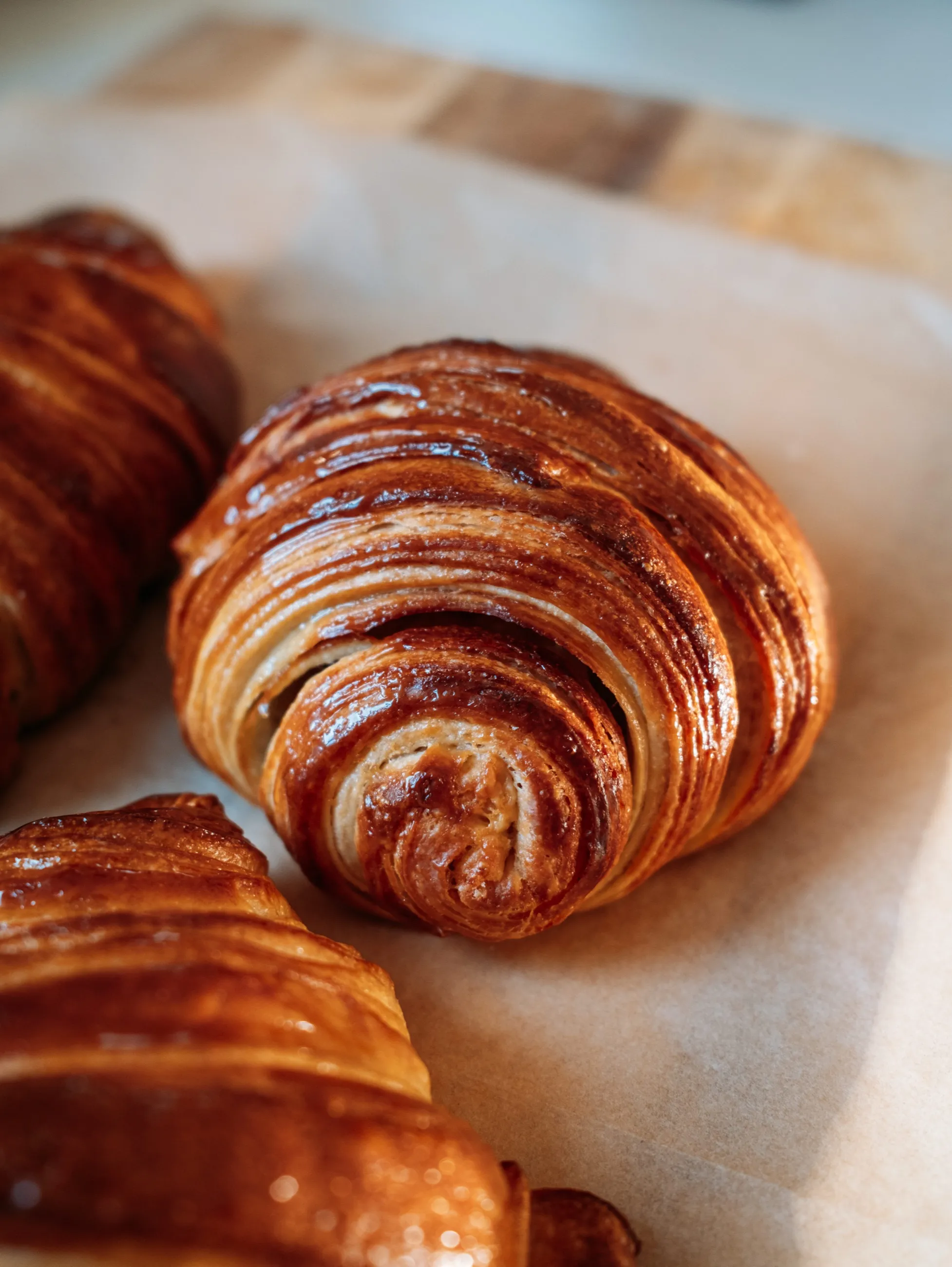 Freshly baked croissants on parchment paper